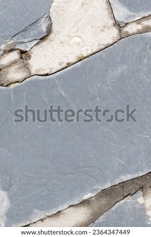 Cement and slate stone floor. Ideal as background, texture and abstract design image. Vertical photo and selective focus.