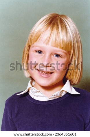 Vintage 1978 roll film yearbook  image of a smiling young girl with blond hair and blue eyes with blue sweater and white blouse.	