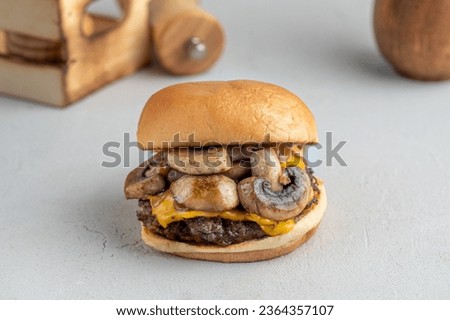A closeup of a freshly prepared hamburger with mushroom, beef and cheese