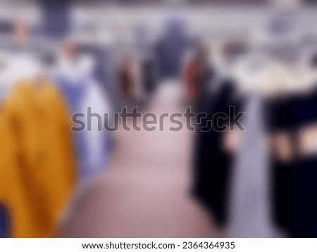 Defocused Abstract Background aisle of female clothes store hanging on rack in front of the store inside modern Shopping Mall or Shopping Center. with vintage tone effect