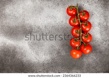 Tomatoes on marble texture background. Cherry tomatoes, yellow, pink, brown and black tomatoes in a bowl. Organic vegetables, harvesting.Vegan. Fresh ripe tomatoes. copy space.