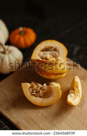 Still life of orange and white pumpkins on a rustic wooden board. stock photo