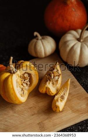 Still life of orange and white pumpkins on a rustic wooden board. stock photo