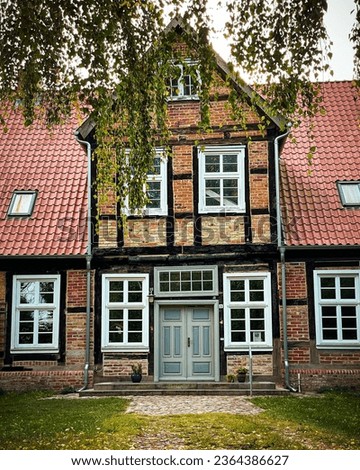 old crooked northern German half-timbered house Royalty-Free Stock Photo #2364386627