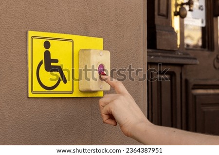 A person with a disability presses the button to call the staff.