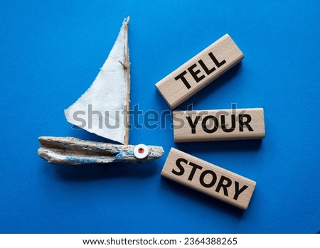 Tell your story symbol. Wooden blocks with words Tell your story. Beautiful blue background with boat. Business and Tell your story concept. Copy space.