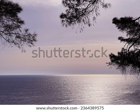 Sea glittering water at sunset evening time. Royalty-Free Stock Photo #2364389575