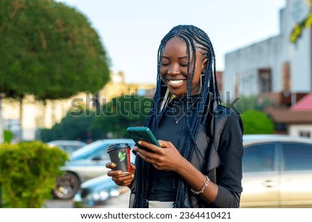 young black woman with braids engrossed in her phone, capturing the intersection of technology and African culture