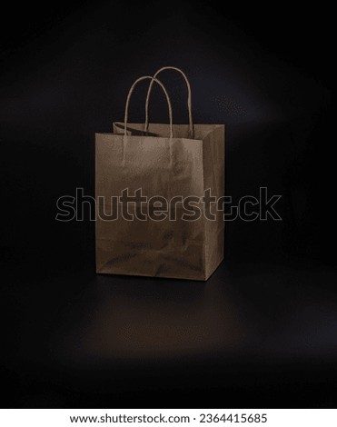 paper bag with handles on a black background
