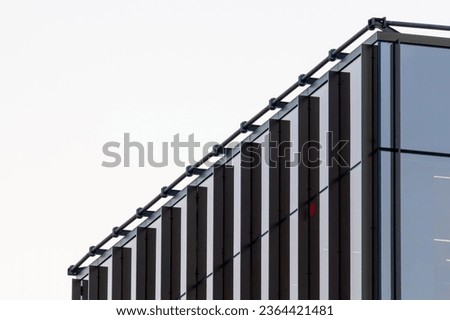Fragment of an office building with metal and glass. Commercial office buildings. Abstract modern business architecture