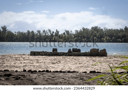 An ancient Marae at the edge of a lagoon on the island of Huahine in French Polynesia. 
