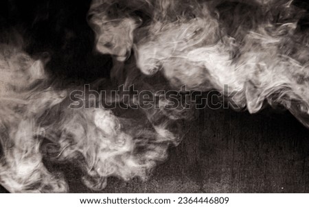 Billowing cloud of white smoke against dark background. Royalty-Free Stock Photo #2364446809