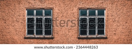 detail of brick facade with two mullioned windows
