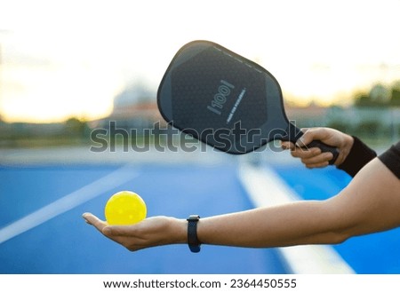 Pickleball tennis racket. Background with copy space. Sport court and ball. Royalty-Free Stock Photo #2364450555