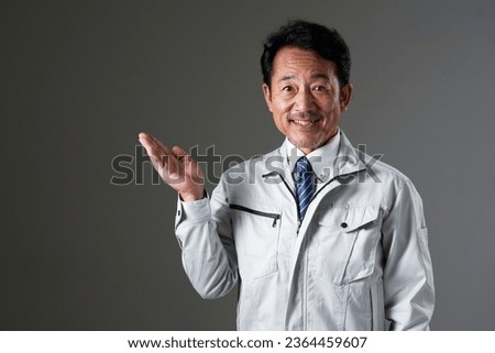 Asian middle aged worker in black background