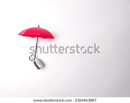 Silver padlock and red umbrella on a white background with copy space.