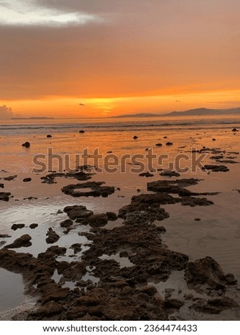 Between the sturdy rocks and gentle waves, the ocean tells an eternal story of struggle and serenity Royalty-Free Stock Photo #2364474433