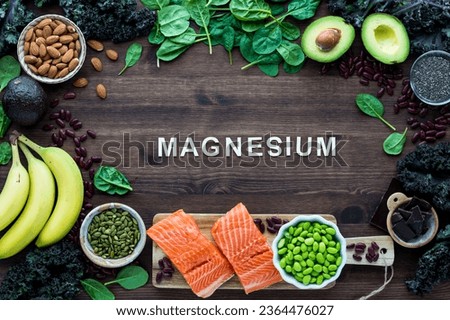 Healthy foods forming a border with the word Magnesium in the middle. Royalty-Free Stock Photo #2364476027