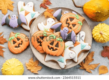 Multicolored Halloween homemade cookies on white wooden  background.