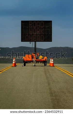 Vertical image of a Digital Road Sign stating Road Work Ahead