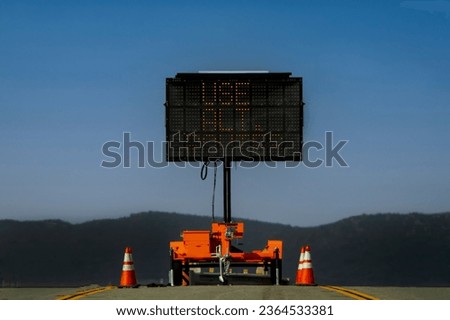 Digital sign stating Use Alternate Route against a blue sky