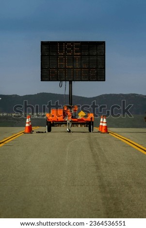 Vertical image of a Digital Road Sign stating Use Alternate Routes