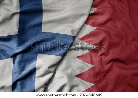 big waving national colorful flag of finland and national flag of bahrain . macro