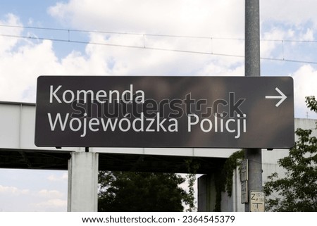 Police information direction road sign in Poland, indicating the location of a police station. Letters in Polish language, Komenda Wojewódzka Policji means Provincial Regional Police Headquarters.