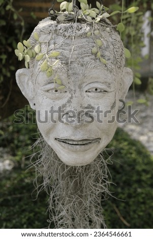 Vertical Photo of Crafted botanical sculpture of human Head figure Sculpture. Abstract art with intricate plant design. Royalty-Free Stock Photo #2364546661
