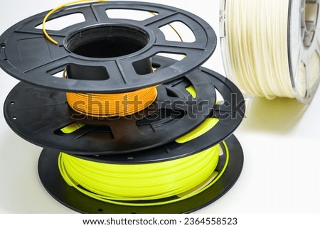 spools of 3D printer filaments on a withe background