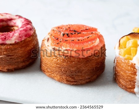 Assorted croissant donuts on a marble background