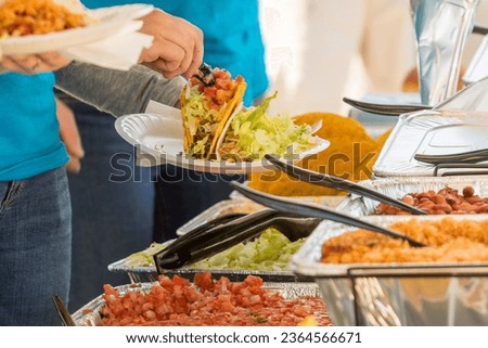 Horizontal Photo focused on hand preparing Fresh Tacos, vegetable dish, healthy, delicious meal. Perfect for food-related concepts.