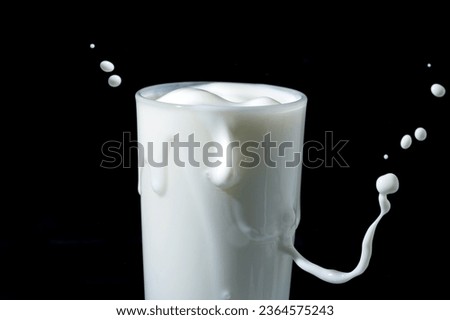 milk or white liquid splash isolated on black background 