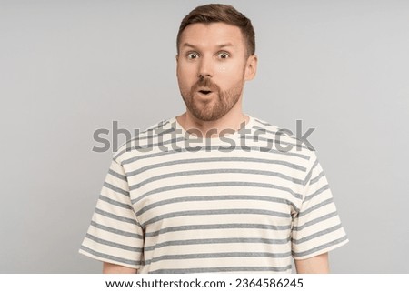 Astonished man looking open mouth in amazement, omg, surprised from ad offer opportunity. Shocked middle aged caucasian male with excited expression round eyes, isolated studio background. Omg, wow Royalty-Free Stock Photo #2364586245