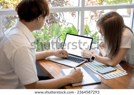 Graphic designer consulting a client at office