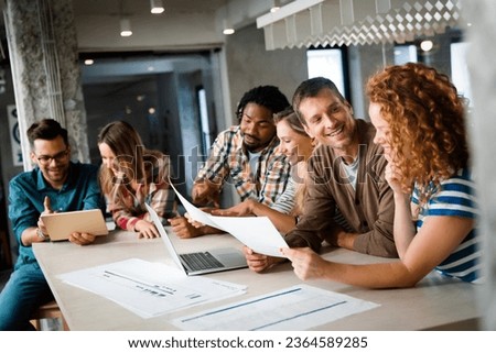 Smiling diverse colleagues gather in boardroom brainstorm discuss financial statistics together Royalty-Free Stock Photo #2364589285