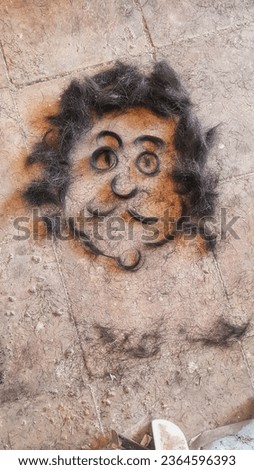 a picture of a longish man's face with a mustache from haircuts on the tile floor
