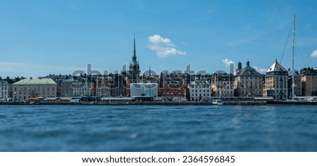 Stockholm Sweden. Gamla Stan, panoramic view of Old Town, Traditional waterfront colorful building, boat at port, blue sky background. Banner