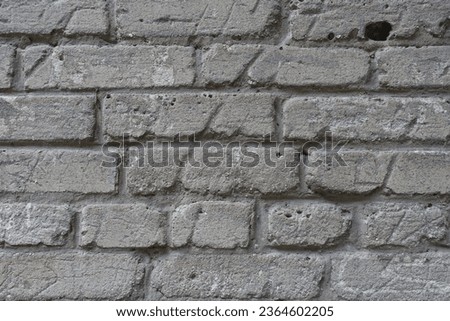 Uneven surface of old and scratched grey brick wall Royalty-Free Stock Photo #2364602205