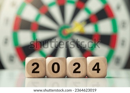2024 New Year goal plan action Concept.Wooden cubes with 2024 in front of the target dartboard.Goal achievement and success in 2024.Business plan and strategies. planning, new year resolution.
