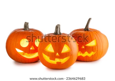 Three glowing Halloween Pumpkin lanterns isolated on white background