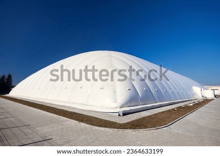 Inflatable air dome stadium. Inflated Tennis air dome or Tennis bubble arena. Modern urban architecture example as pneumatic stadium dome. Royalty-Free Stock Photo #2364633199