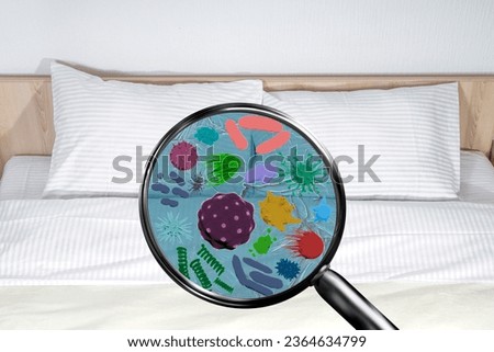 Magnifying lens with simulated germs, viruses, bacteria, hygiene concept. Double bed, white bed sheets and pillows in a hotel room or at home Royalty-Free Stock Photo #2364634799