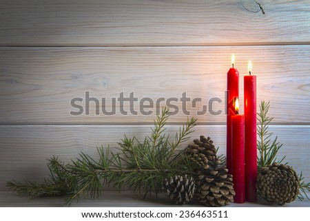Christmas wooden background with candles and a space for text 