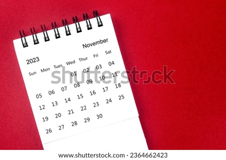 November 2023 Monthly desk calendar for 2023 year on red background.