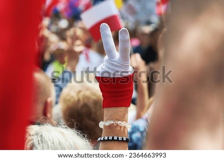 A man's hand and two fingers form the letter V. Freedom. Royalty-Free Stock Photo #2364663993