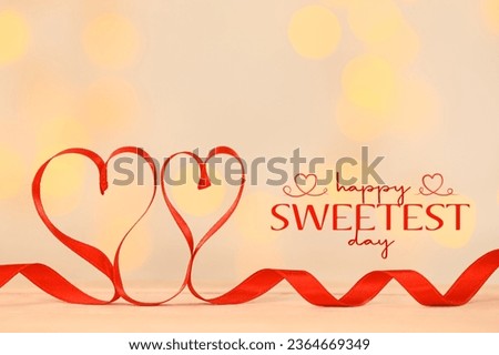 Hearts made of red ribbon on beige background. Happy Sweetest Day  Royalty-Free Stock Photo #2364669349
