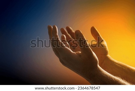 Hand praying on light yellow background.
