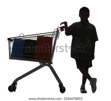 Silhouette of little boy with shopping cart on white background