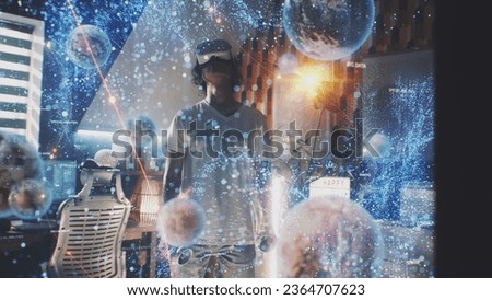 Man uses augmented reality goggles and wireless controllers at home. 3D computer graphics visualization of holographic immersive metaverse big data and virtual cyberspace. Futuristic VFX animation. Royalty-Free Stock Photo #2364707623